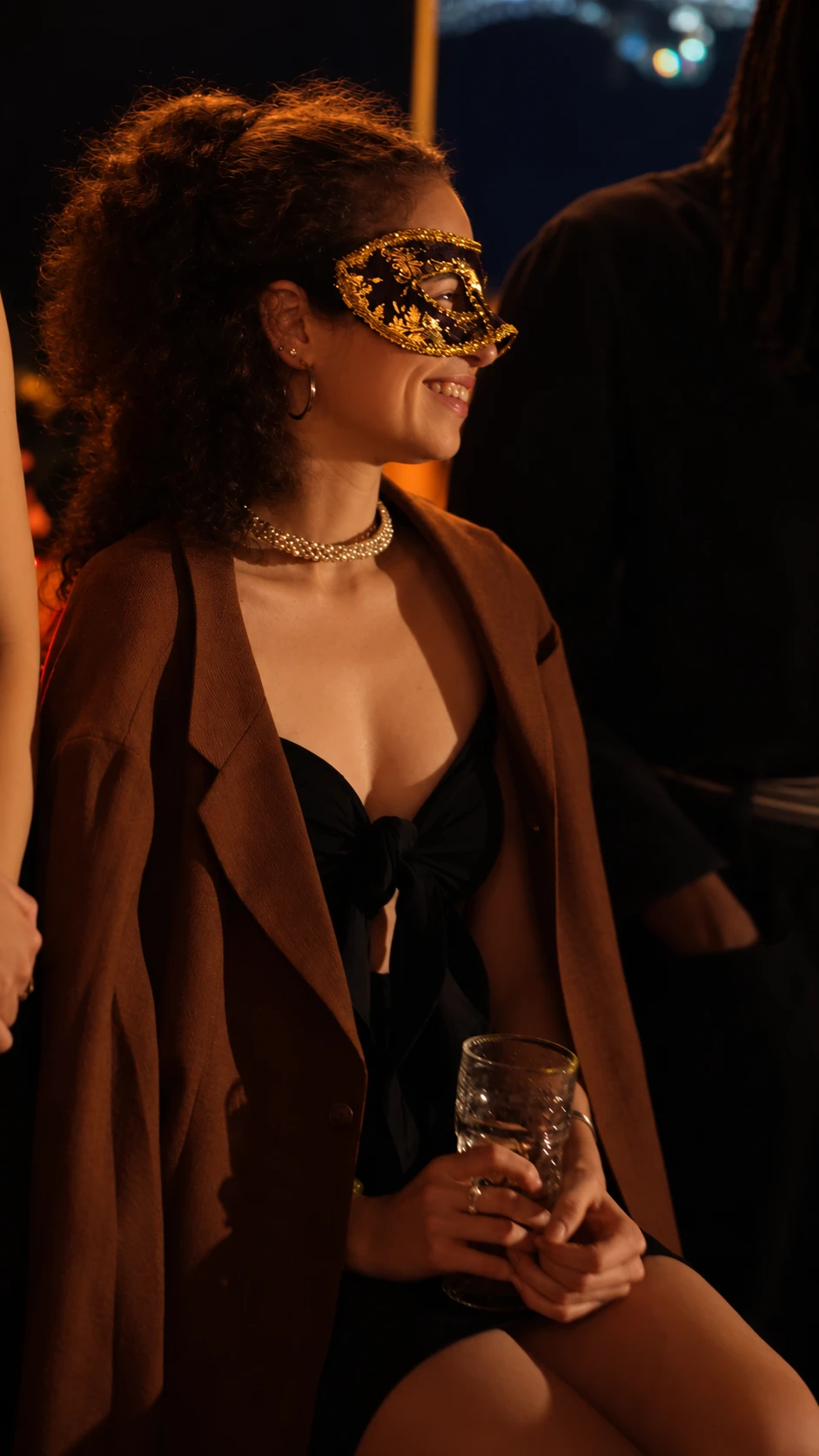 A guest in a gold mask, smiling